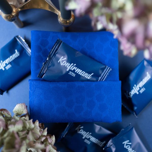 Blue CONFIRMATION BAGS WITH WHITE PRINT FILLED WITH HANDMADE BUNCHES: PERFECT TABLE DECORATIONS FOR CONFIRMATION